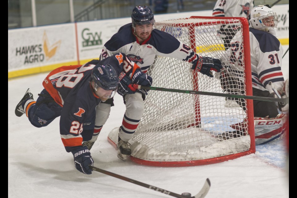 Glentworth's Tristan Sulz and Assiniboia's Scott Anderson battle for control of the puck behind the Thunder net, as goalie Clayton Schmidt keeps a watchful eye.