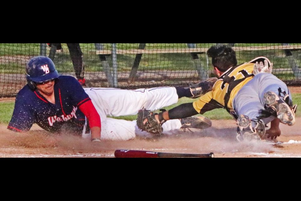 Weyburn Beavers player Braeden Cordes safely slid in to home plate past the outstretched glove of the Edmonton catcher, to score the Beavers first run on Friday evening