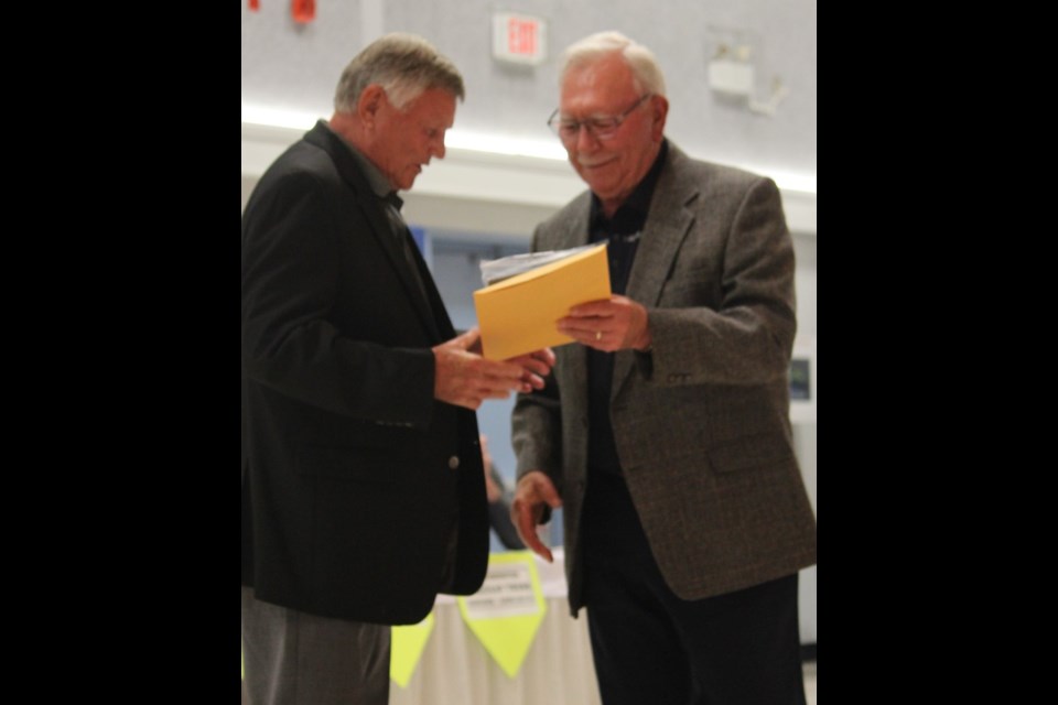 Louis Green died in 2010 so accepting his award this year was friend and former teammate Don Hilsendager (left). Presenting the award is board member John Yarske. 