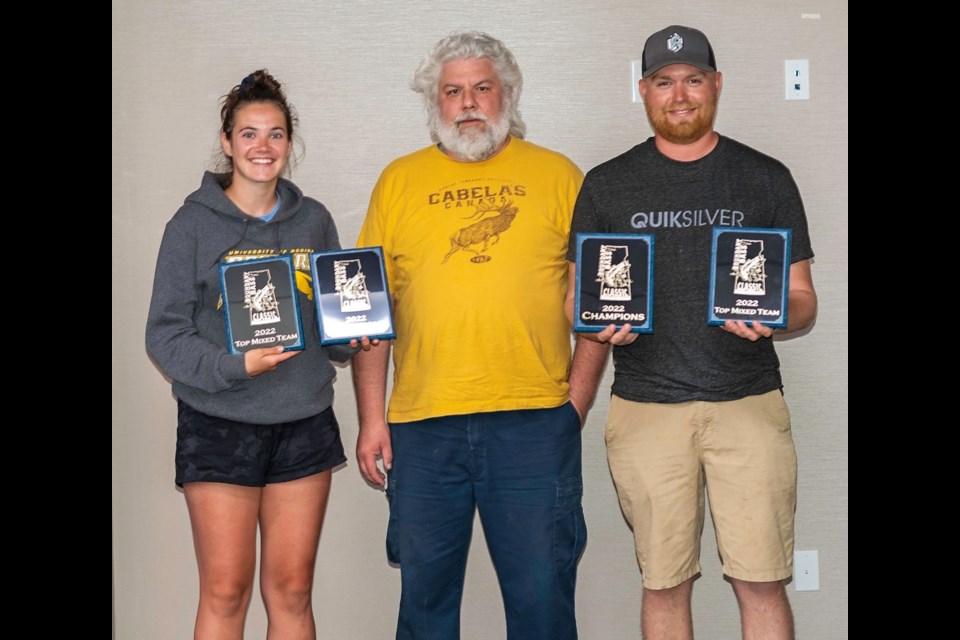 Brooke Werner, left, and Bryce Godin accept their championship plaques from James Turner.