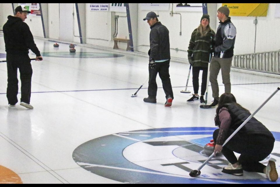 A curler makes her shot during Weyburn's annual Boxing Day Bonspiel on Sunday