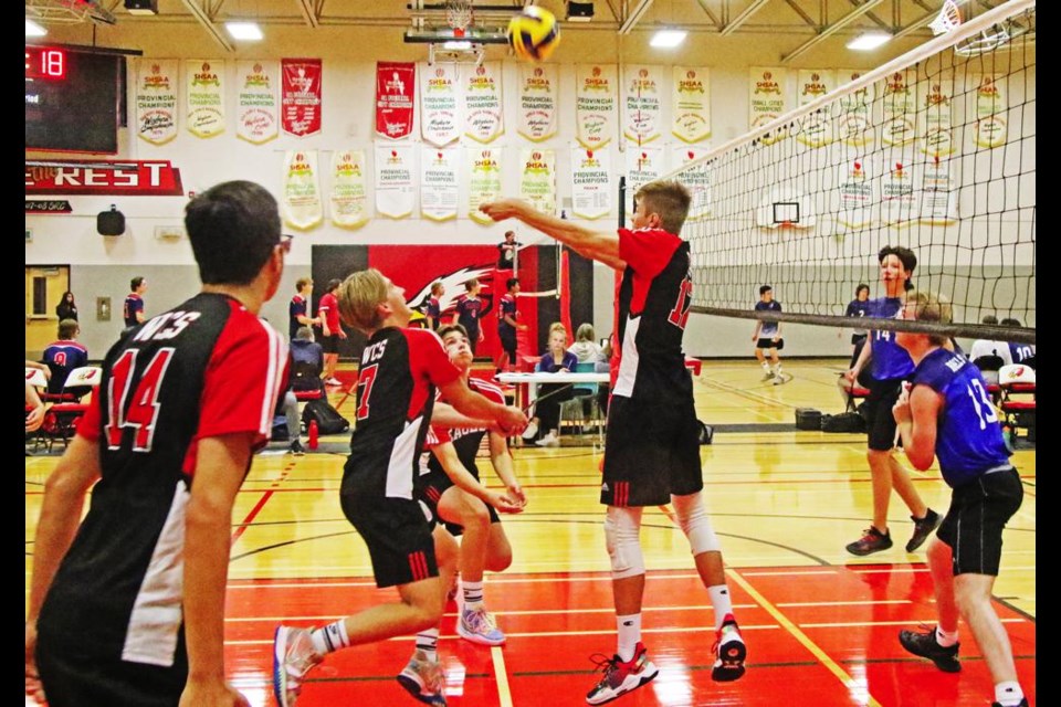Comp Eagles player Marcus Keating bumped up the ball as his teammates were at the ready if needed, during a round-robin game vs Rouleau on Friday for the senior boys volleyball tournament.