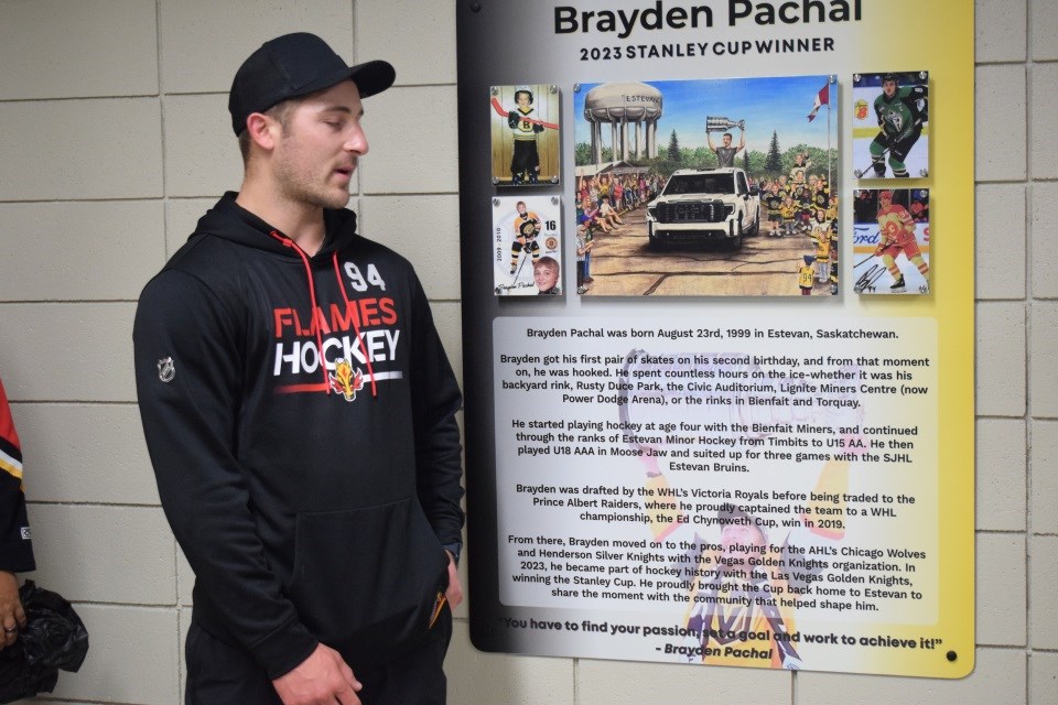 Brayden Pachal speaks near the plaque. 