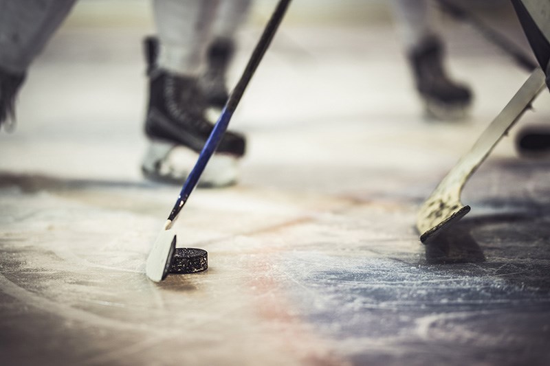 Close up of hockey puck and stick