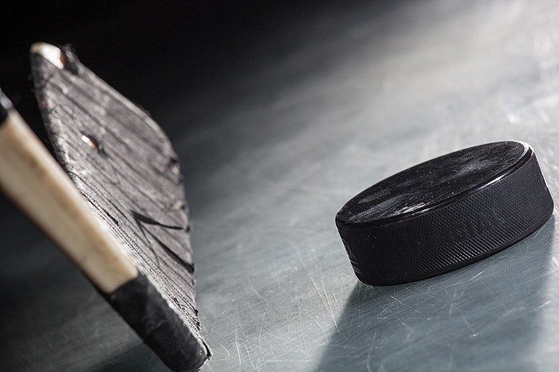 Close up on hockey puck and stick