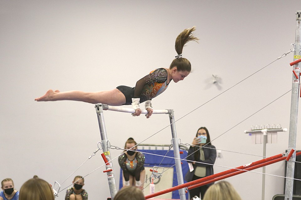 Brooklyn Kelly competes in the bar event at the Calico Gymnastics Club’s competition on Feb. 12.