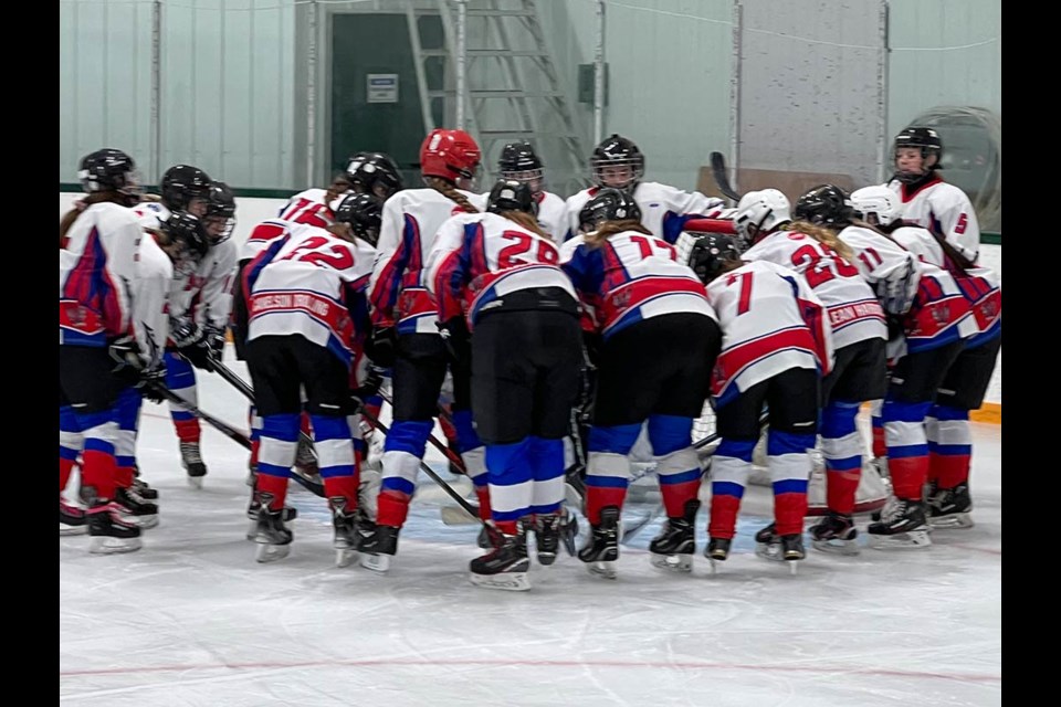 The female U18 Carlyle Wildcat team circles their goalie for the uplifting team spirit chant before the game.