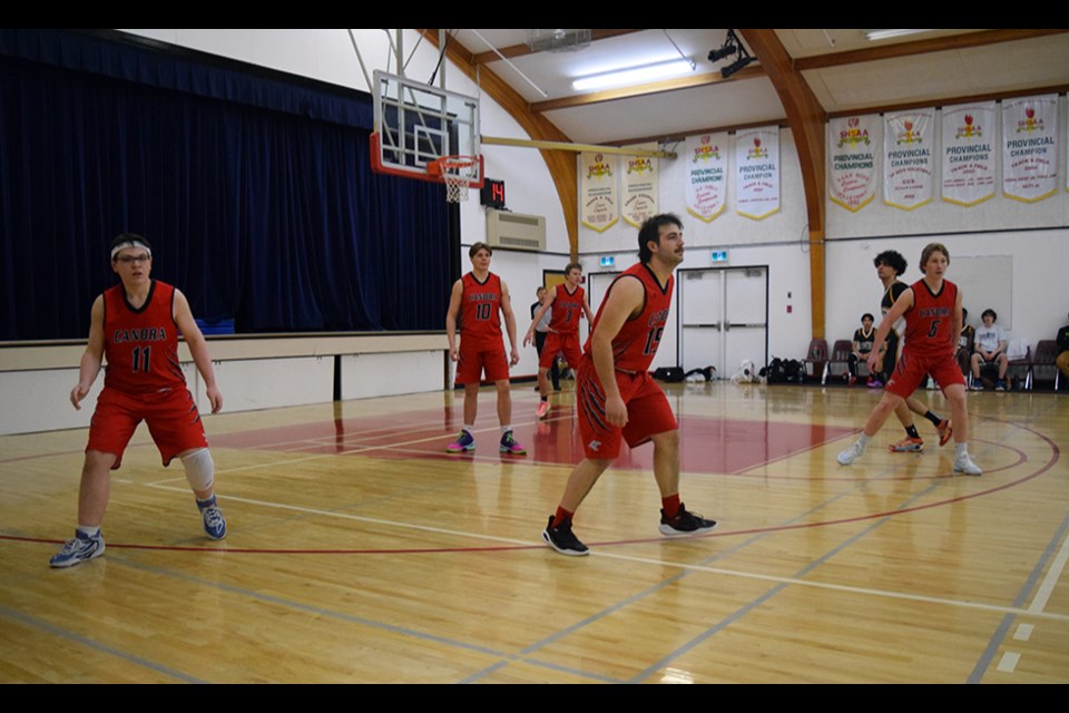 After getting out to a quick 14-4 lead, the CCS starters (red jerseys) focused on protecting their basket against the Sacred Heart Saints on Feb. 14. From left, were: Josh Rock, Matthew Makowsky, Linden Roebuck, Andrew Owchar and Briel Beblow.