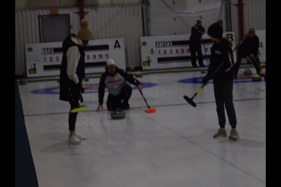 With Jordan Zbitniff (off camera) holding the broom, his dad John released this shot, while mom Amanda (left) and sister Victoria prepared to sweep at the Canora Christmas Bonspiel on Dec. 29.