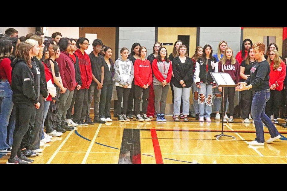 Music teacher Holly Butz, at right, led the WCS choir in singing O Canada just prior to the start of the Co-op Challenge between Weyburn and Estevan on Wednesday evening.