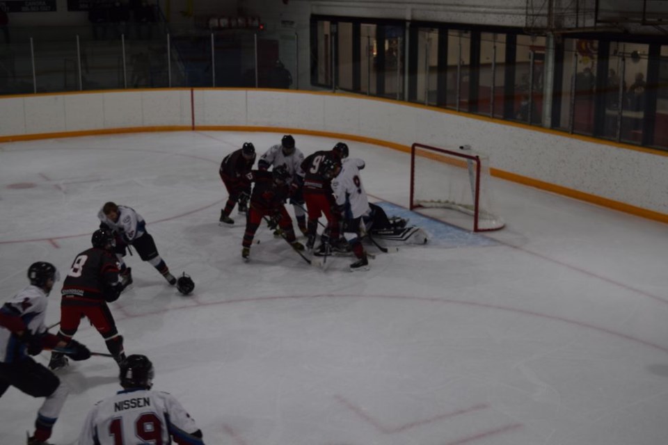 The Canora Cobras (dark jerseys) spent a lot of time in front of the Ituna net at the Canora Civic Centre on December 10, scoring a dozen goals in a 12 to 3 victory. Among the Cobras digging for the loose puck were: Tanner Denesowich, Donnie St. Marie and Skyler Hladun. / Rocky Neufeld