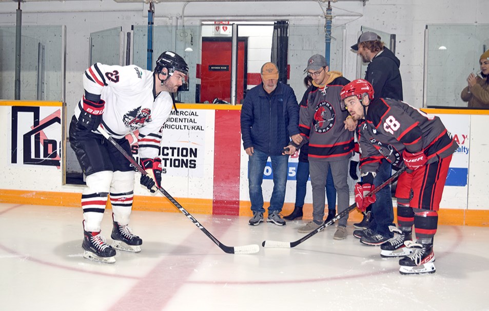 At the Canora Cobras home opener on Nov. 18 against the Swan Valley Axemen, Riley Kowalyshyn dropped the puck between Cobras Captain Ryley Stefanyshyn (right) and Even Morden of the Axemen for the Community Insurance opening faceoff. Accompanying Riley, from left, were Deryl Ortynsky, Joan Kowalyshyn (hidden), and Kelly McTavish. 