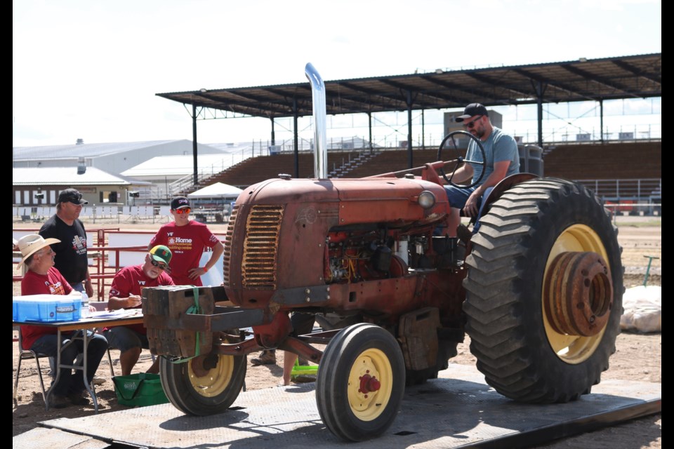 Greg Ketch from Fort McMurray drives the 1953 Cockshutt 50 diesel over the weigh scale.