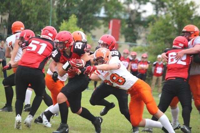 Weyburn Eagles running back Ben Michel (No. 20) sneaks past the defense line of the Yorkton Raiders.