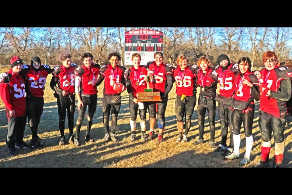 The seniors of the WCS Eagles football team gathered with the SHSAA 5A Provincial Championship trophy in front of the scoreboard on Nov. 11, after winning for the first time ever at Darold Kot Field.