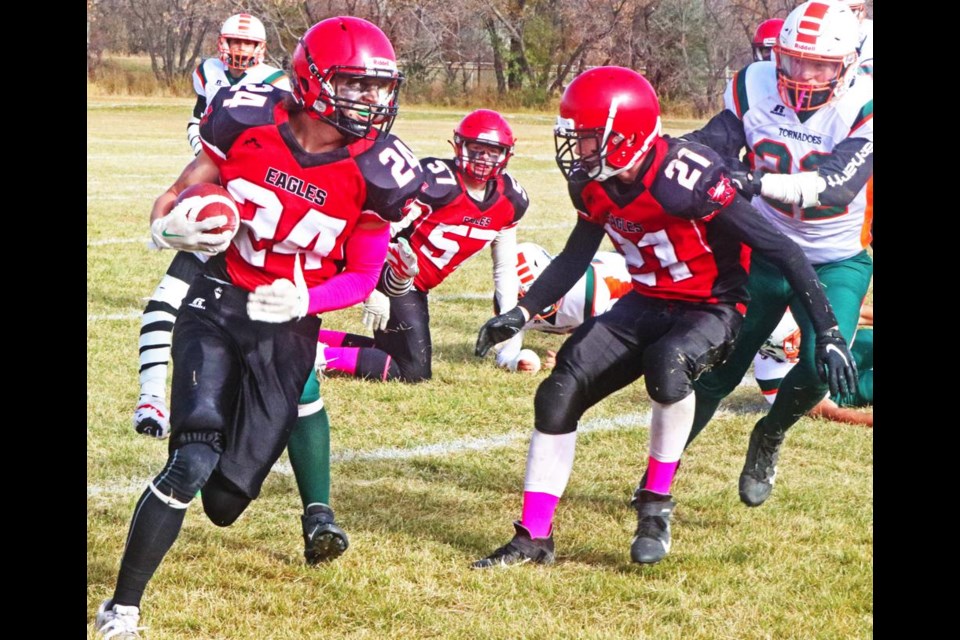 WCS Eagles player Carter Bell looked upfield as he carried the ball on this play in their playoff game vs Moose Jaw Peacock.