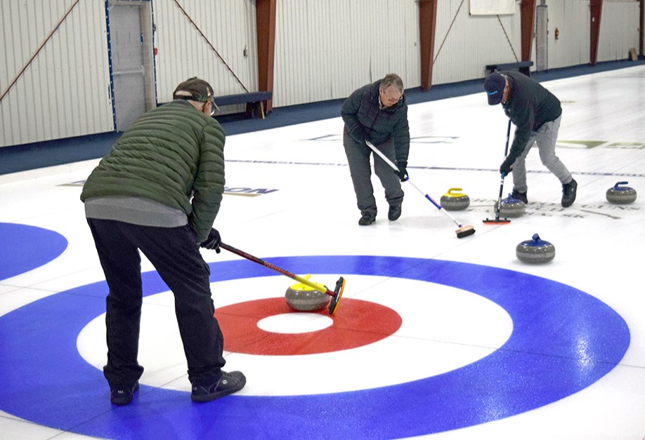 Curling season is underway and the competition was hot and heavy during week one. On Nov. 30, from left, Peter Wiwchar called the line while Sharon Ciesielski and Robert Waselenko provided the sweeping muscle during regular afternoon curling action. Organizers said there is plenty of room for more curlers to join the fun. 