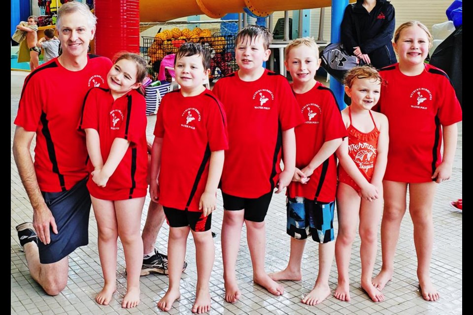 Water polo coach Dave Edgerton is with a squad of minis, including from left, Lola Szczecinski, Rhett Wagner, Kade Wagner, Liam Eddy, Lindsay Kirkpatrick and Julie Labrecque.