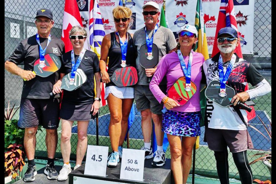 Deana Mainil won silver in the mixed doubles event. Winning gold was Brenda Hawryluk and Steve Elder (centre); silver went to Deana Mainil and David Hesje, and bronze went to Melody Fischer and Norman Kowalchuk.