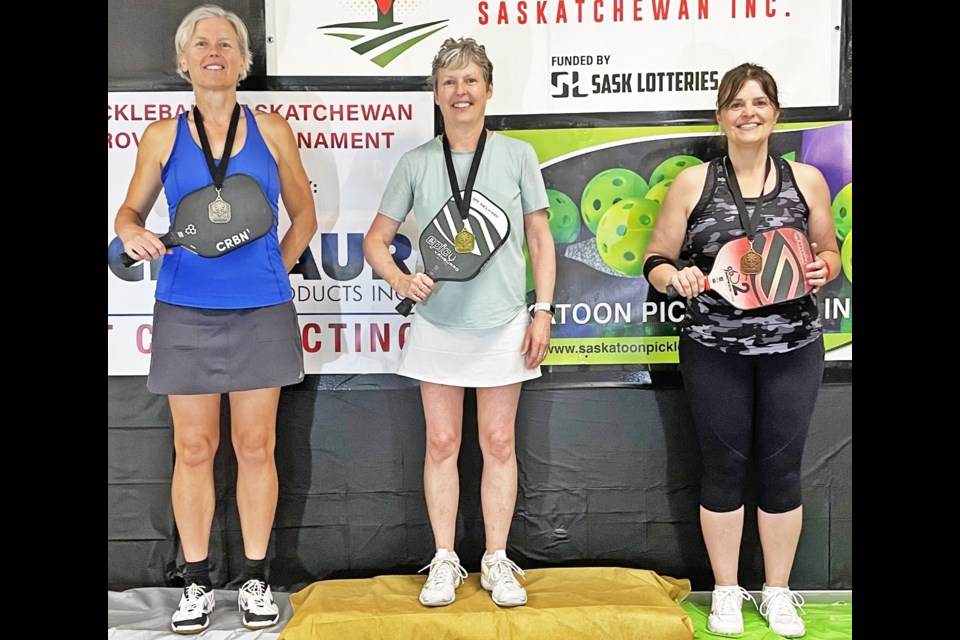 Weyburn pickleball player Deana Mainil, centre, won gold in the women's singles event at the Sask. Pickleball championships in Warman.