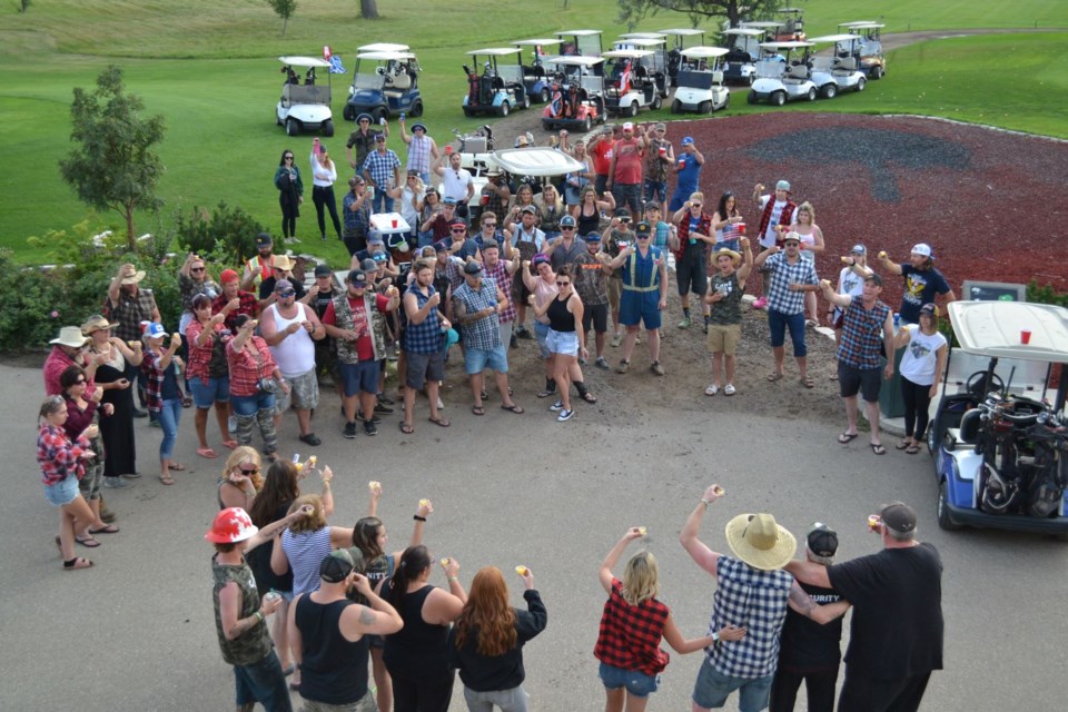 Participants in the Dustin Pratt Memorial Redneck Golf Tournament gathered to honour him with a toast Saturday evening. 