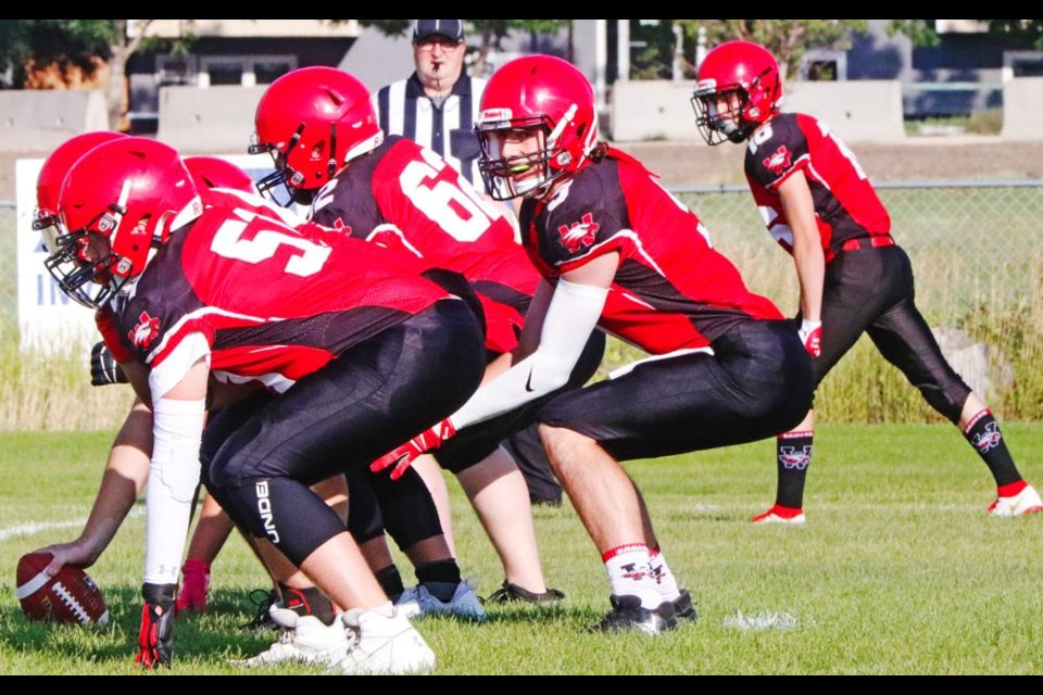 Weyburn Comp Eagles QB Ben Manning yells out the signals on the line, during a controlled scrimmage Friday.