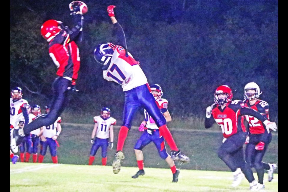 Comp Eagles player Haydin Buehler went up high to make this catch, in spite of the Estevan player also reaching high.