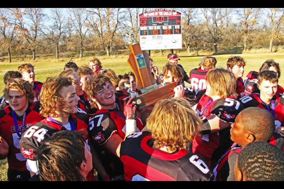 The WCS Eagles celebrated with the 5A Rural trophy in front of the scoreboard displaying the final score of 52-14 over the Yorkton Raiders on Saturday.