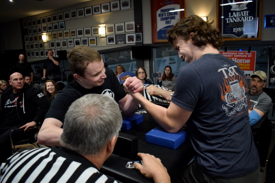 Connor Smith, left, and Cowan Ludtke squared off in the boys' 14-18 division during the Estevan Southern Impact arm wrestling club's first-ever Armageddon competition on Saturday at the Power Dodge Curling Centre. Athletes put their skill and technique to the test. 