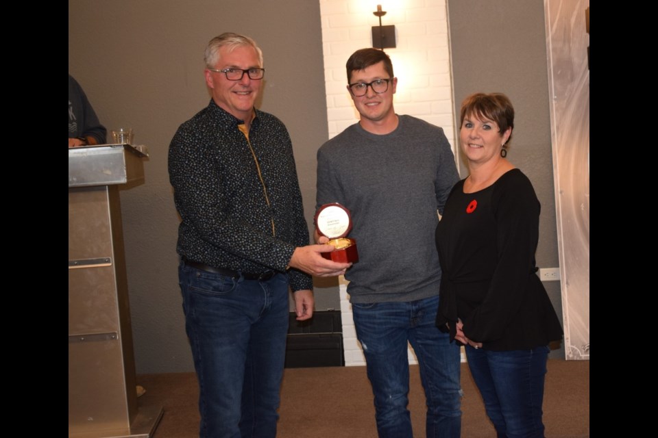 Dave Mack, left, and Joyce Mack, right, were inducted into the Estevan Motor Speedway's Wall of Fame by Aaron Turnbull. 