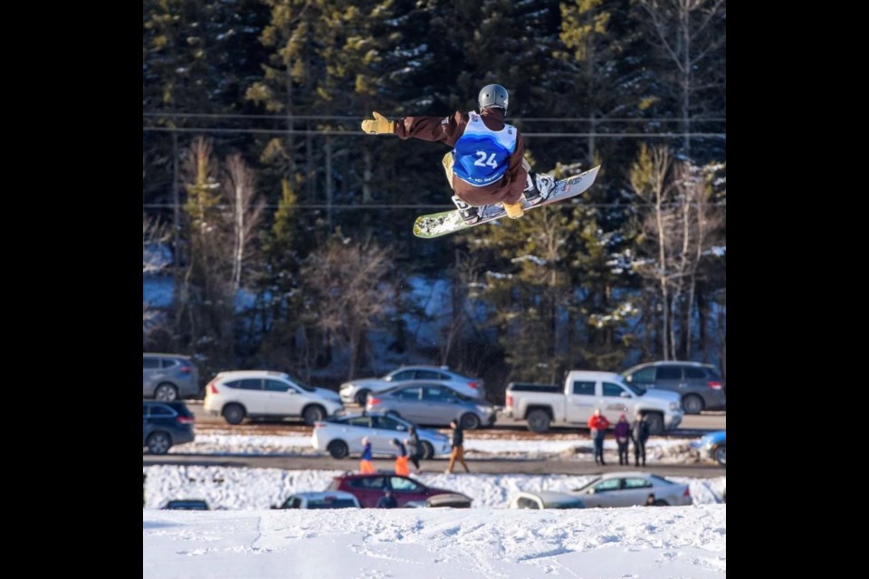 Sebastian Murphy soars through the air in the snowboarding event. 