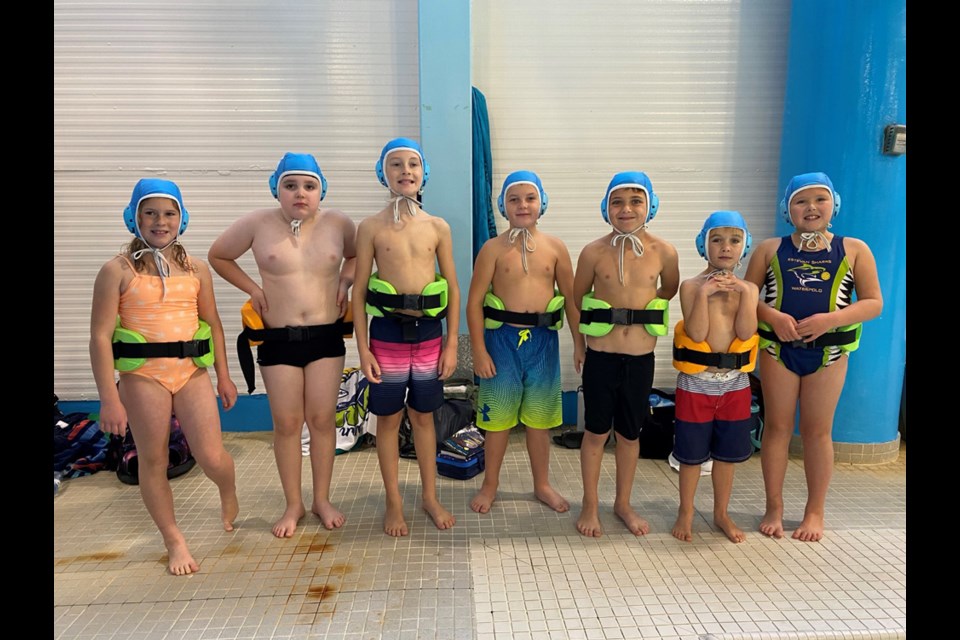 Sharks Blue members are, from left, Brynna Sherling, Jackson Prefontaine, Jaxon Reinhardt, Eoin Jones, Aksel Senholt, Laine Petterson and Nicolai Mitchell. Missing are coaches Kristy Jones and Alan Smelt.