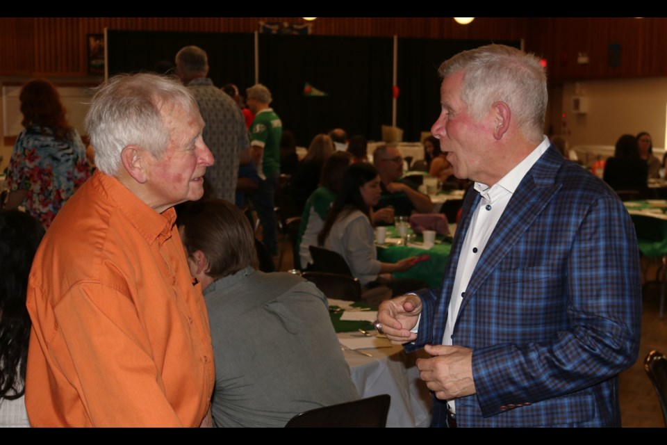 Keynote speaker Brain Dobie, right, talks to Barry Sharpe.
