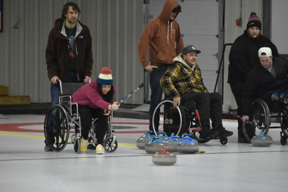 At the Fifth Annual Wheelchair Curling Funspiel at the Broda SportsPlex in Kamsack on Jan. 5-6, Jayden Raabel secured the wheelchair as Cassidy Aker threw a stone. Watching intently were Colton Crowdis, Teddy Hudye, Keanan Sperling, and Jordan Protsko.