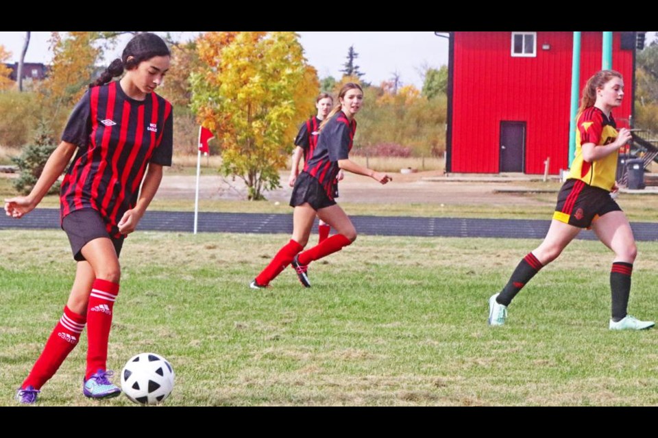 Assiya Benabdallah, left, of the Weyburn Eagles girls soccer team, moved with the ball to Moose Jaw's zone.
