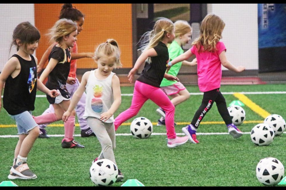 U5 girls took part in a fun drill at soccer practice at the CU Spark Centre