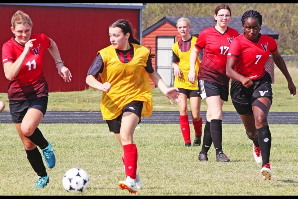 A Comp Eagles player (in yellow) moved the ball up the field pursued by players for Moose Jaw Vanier. The Eagles won their game 3-1.