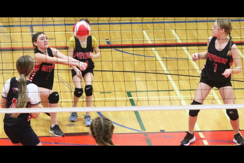 WCS Eagles player Roxy Bowes bumped up a serve as her teammates watched, as the black squad took on Weldon from Bienfait in the district finals on Wednesday.
