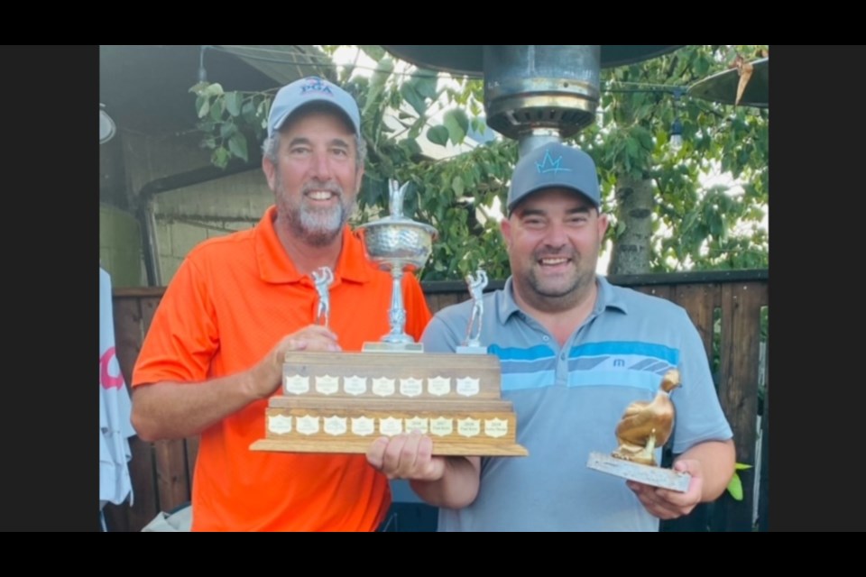 Darren Driscoll, left, owner of the Madge Lake Golf Resort, presented the Golden Duck championship award to Derek Chez of Swan River, Man.