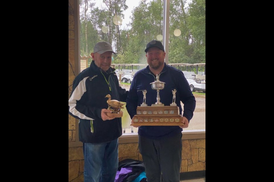 Chris Burton of Yorkton was declared the 2021 Golden Duck Men’s Champion. Tournament organizer Rich Patterson, left, presented Burton with the coveted golden duck and winner’s trophy.