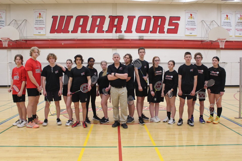 Coach Ken Parker stands amongst his senior badminton team as they prepare to compete in and host a trio of SHSAA playoffs.