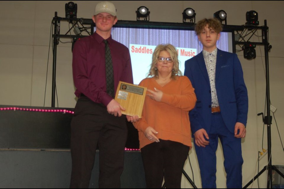 The Preeceville Minor Hockey Association acknowledged players, parents, coaches, fans and all volunteers for a successful season of hockey with a supper and awards banquet on April 9 at the Preeceville Community Hall. Award winners included Canora players who played for the U18 Pats. Thomas Hauber, left, received the Karen Thiel memorial award for best defenseman. Making the presentation were Sherry Kwasnica and Riley Kuta.