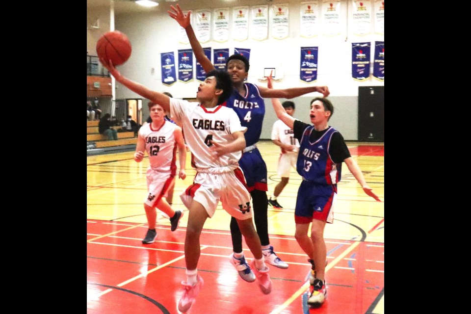 WCS Eagles player Bernard Mariano laid up the ball for a basket as teammate Chace Kradovill came in close behind