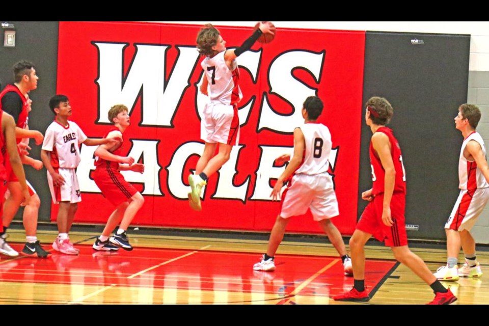 WCS Eagles player Thomas Olson made a big jump to get the rebound after an attempted basket by Oxbow on Saturday