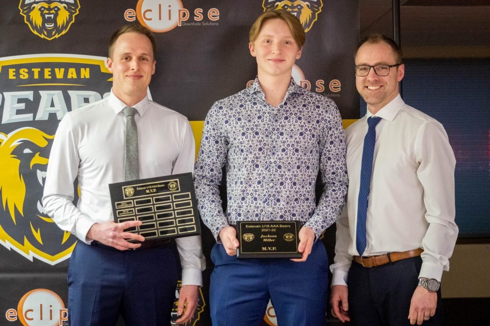 Jackson Miller, middle, accepts the team MVP award from interim head coach Riley Hengen, left, and interim assistant coach Blake Jamieson. 