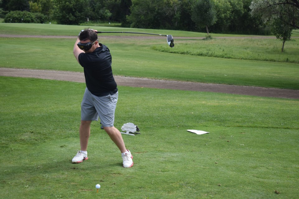 Dusty Smyth tees off while wearing the beer goggles. 