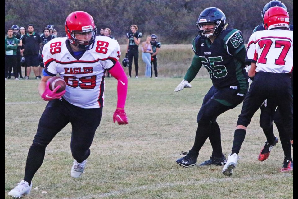Weyburn Jr. Eagles player Owen Istace looks for running room as he went around the end of the offensive line in a game against the Lumsden Devils on Wednesday.