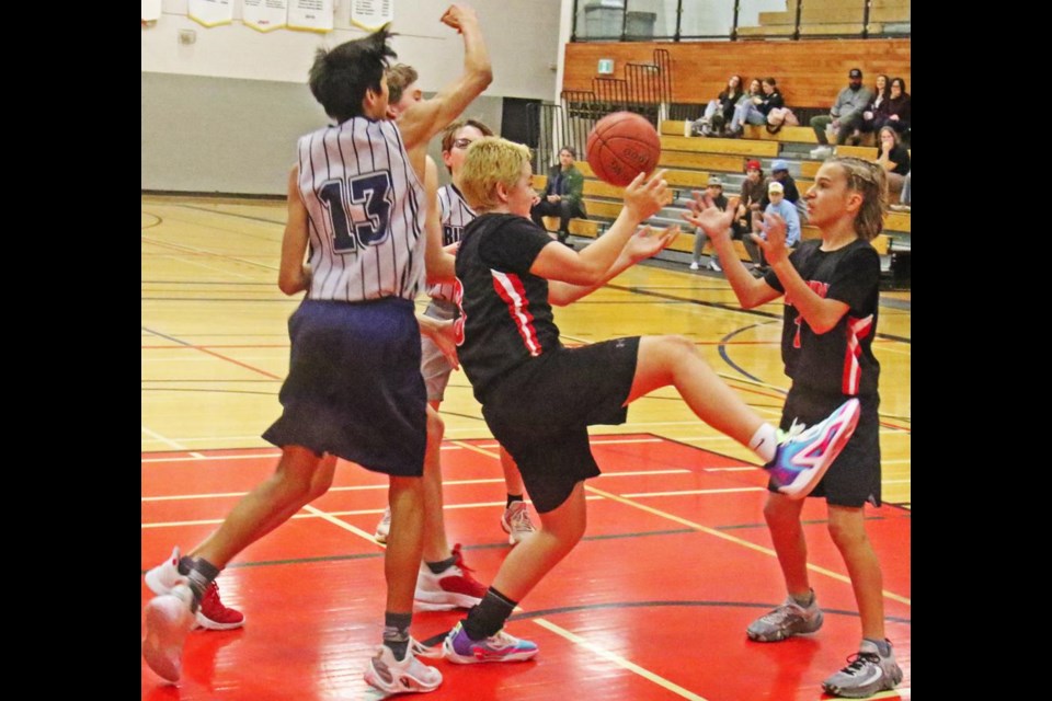 Weyburn and Stoughton players fumbled as they attempted to grab the rebound, after an attempt for a Weyburn basket on Friday.