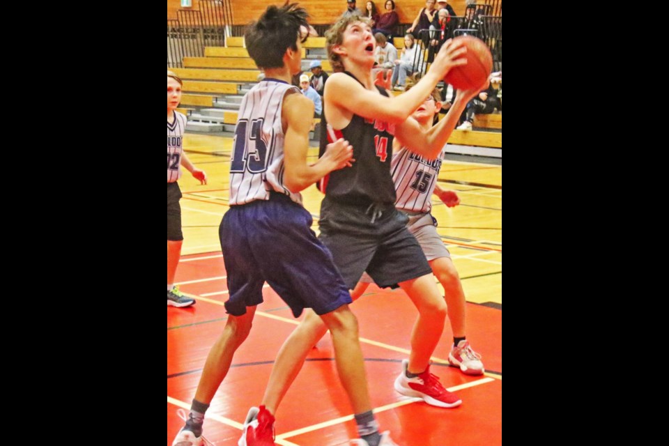 WCS Eagles player Jacob Gill looks up at the basket before making an attempt to score, during their game vs Stoughton in January.