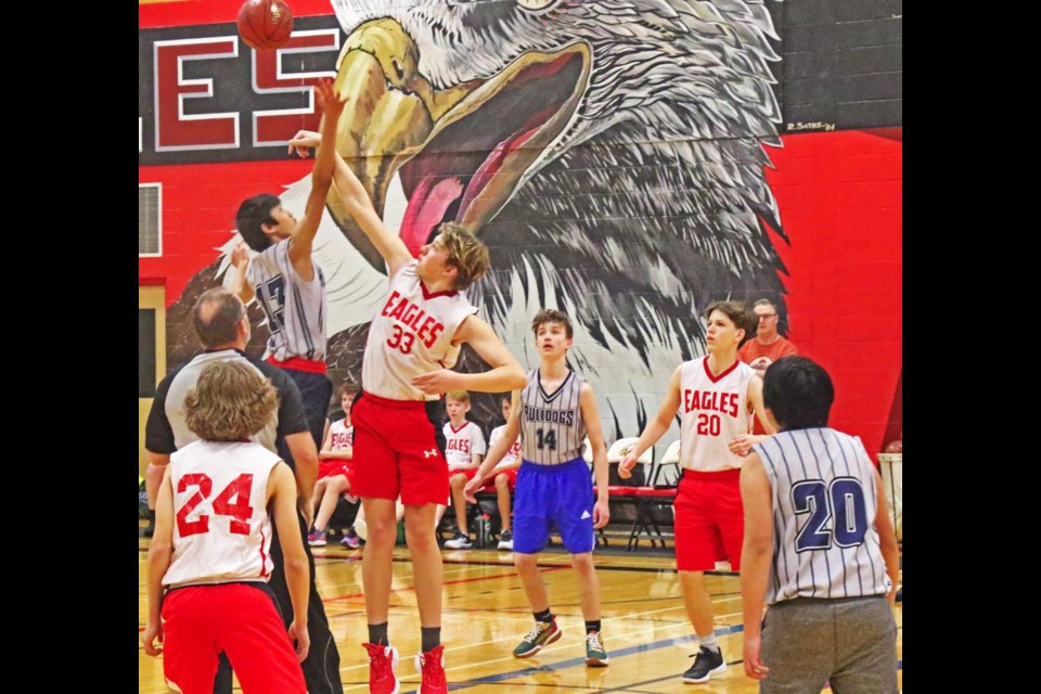 WCS Eagles player Jacob Gill went up against Vigo Orpiano of Stoughton for the jumpoff to start their game on Friday.